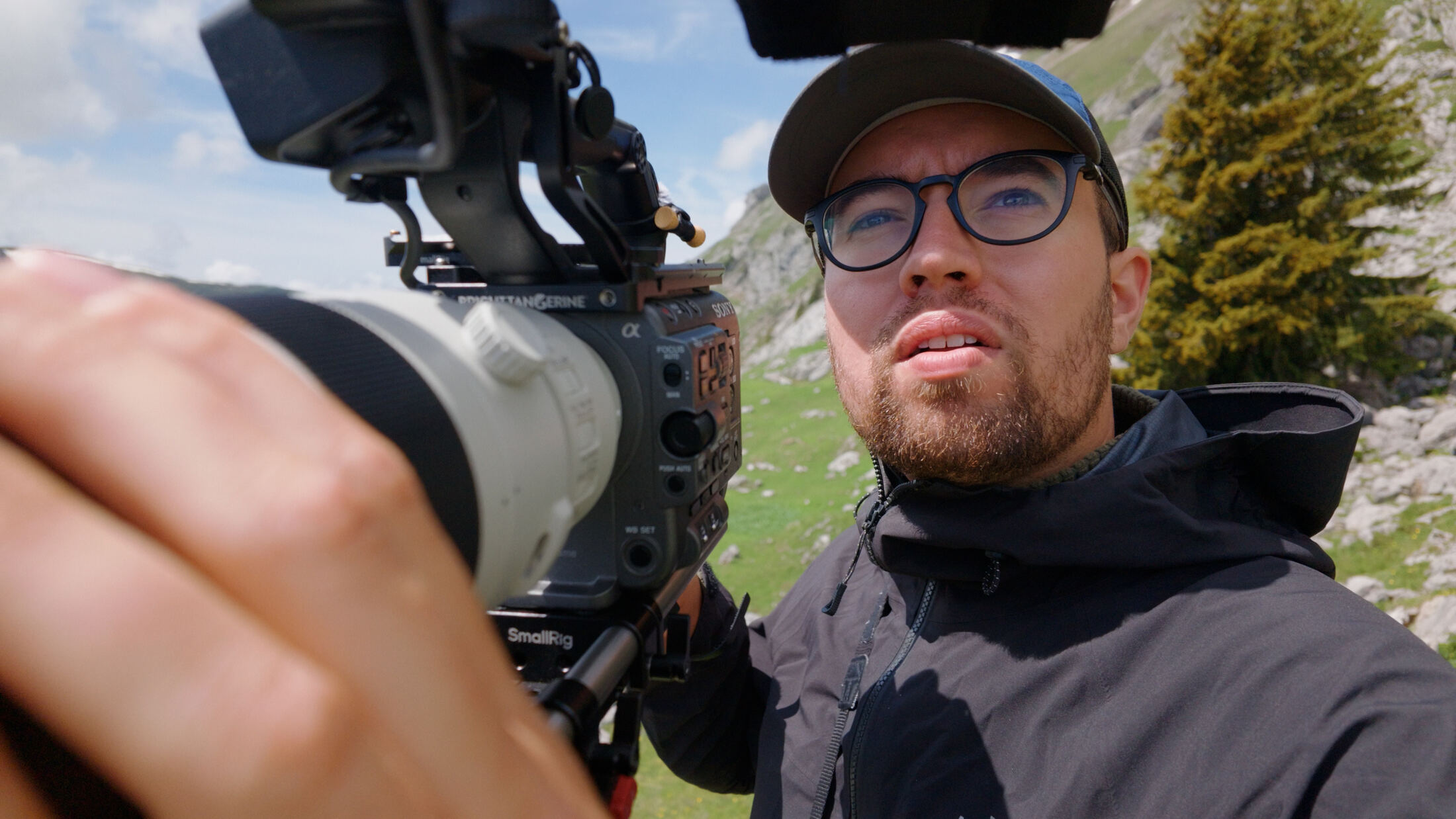 Filmmaker close to camera in the field